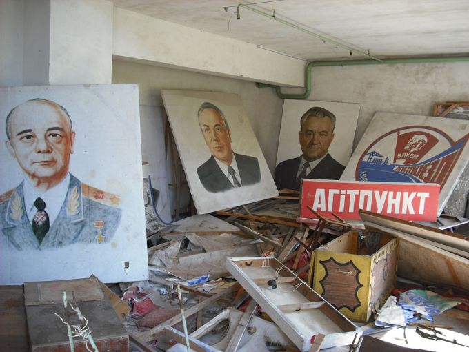 Vemos el mismo cuarto con cuadros de personajes políticos y tremendos daños en todo